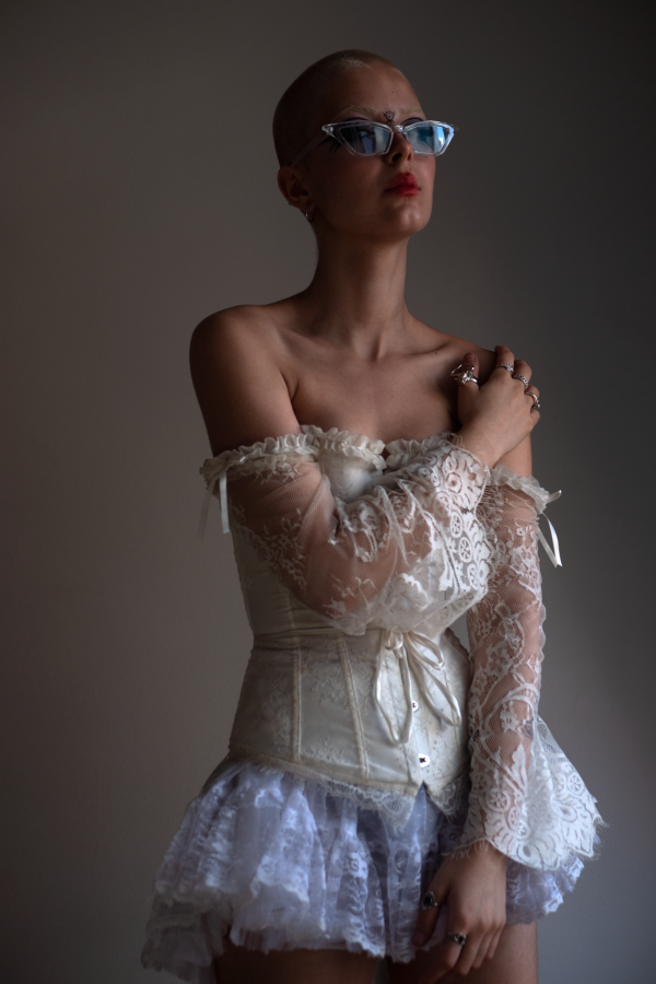 Portrait en dentelle blanche, lunettes bleues, épaule dénudée — photographie de Claude Quéré